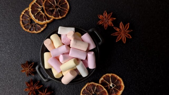 Mini marshmallows in white, pink, and pastel colors, a colorful Christmas dessert. Marshmallows as a food background for your design