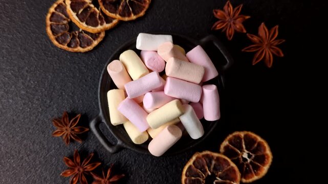 Mini marshmallows in white, pink, and pastel colors, a colorful Christmas dessert. Marshmallows as a food background for your design