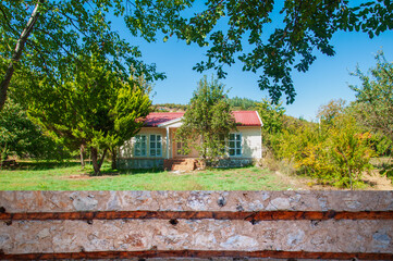 A single-story detached house in a garden.