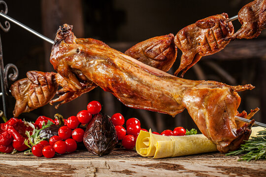 Whole roasted rabbit with quail on spit
