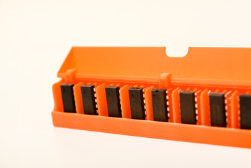 Microchips in a plastic case. Integrated circuits in a plastic storage case. Electronic chips.