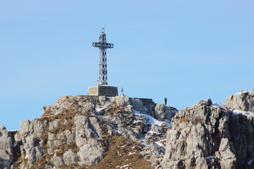 Fototapeta premium The sharp rocks and the summit cross of Mount Resegone, a popular hiking and climbing destination in the Italian Alps