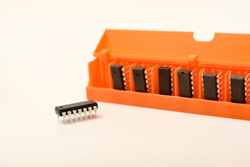 Microchips in a plastic case. Integrated circuits in a plastic storage case. Electronic chips.