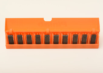 Microchips in a plastic case. Integrated circuits in a plastic storage case. Electronic chips.