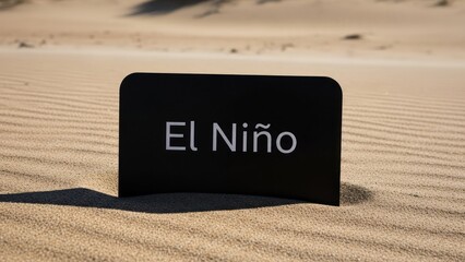 Black sign reading "El Niño" stands in rippled sand dunes under harsh sun