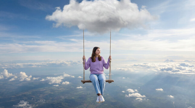 A moment of joy as an adolescent swings beneath a cloud in the sky