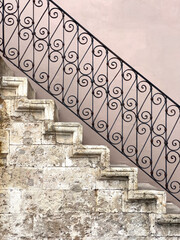 Ancient stone staircase with wrought iron railing detail