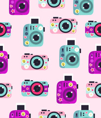 Pattern of cameras with stickers on a light pink background.