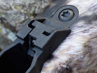 Close-up of a rifle's magazine release lever