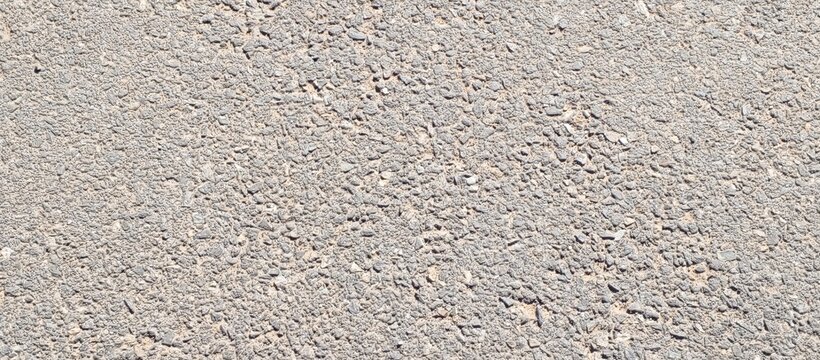 high-resolution gray asphalt road surface texture with small gravel and rough pattern, ideal for backgrounds and industrial design