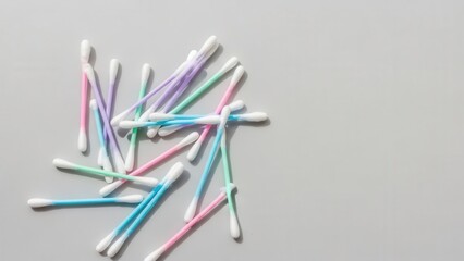 scattered pile of multicolored cotton swabs with pastel pink, blue, purple, and green stems
