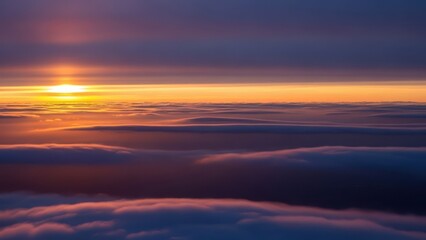 Fototapeta premium Sun emerges over vast, colorful cloudscape at dawn