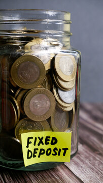 Kolkata, India, dated 28.12.2025. Glass Jar with Indian Rupee Coins Representing Savings, FD and SIP Investments