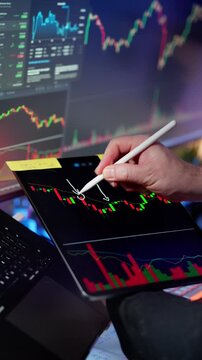 Cryptocurrency technical analysis tablet trading charts blockchain market professional hand using stylus highlighting candlestick signals digital interface financial data visualization volatility
