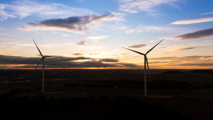 Wind Turbines at Sunset Over Rural Landscape, Renewable Energy Concept