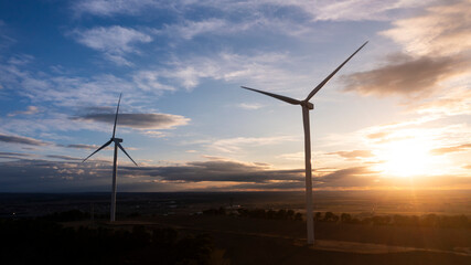 Wind Turbines at Sunset Over Rural Landscape, Renewable Energy Concept