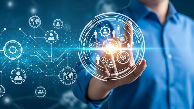 A person in a blue shirt interacting with a glowing digital interface displaying interconnected of people and gears - Powered by Adobe