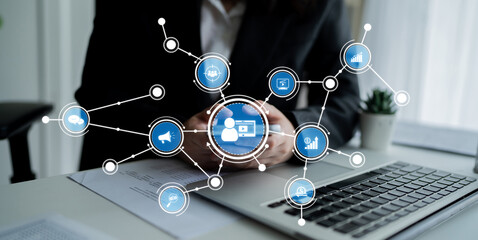A professional workspace featuring hands holding a smartphone, a laptop on the desk, and digital icons representing data analysis and connectivity in a modern office environment. Crux