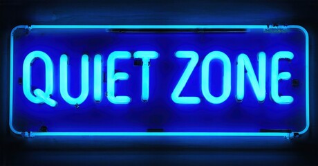 Obraz premium Bright blue neon sign displays Quiet Zone. Rectangular shape, dark background, simple text presentation. Minimalist design, glowing illumination.