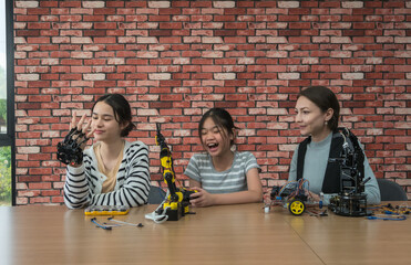 Teacher and student group of diverse individuals collaborating on robotics project in modern workspace. assembling and programming robotic arms, showcasing teamwork, innovation, and STEM education.