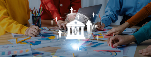 Professionals gather around a table, analyzing charts and financial data. Hands actively engage with documents, fostering collaboration on market trends. Trope