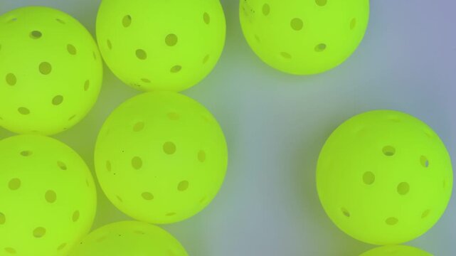 Yellow pickleball balls in a white background close view