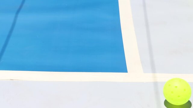 Pickleball balls in a court floor. View of the balls and with copy space