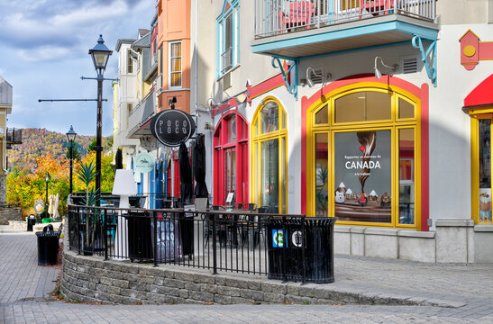 October 7, 2025, Mont-Tremblant, Quebec, Canada. Colorful storefronts and a cozy caf&eacute; terrace brighten a pedestrian street, offering a charming urban scene ideal for travel and lifestyle design