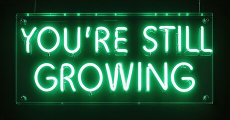 Bright green neon sign displays positive message. Dark background emphasizes glowing text, simple design. Encouraging words present.