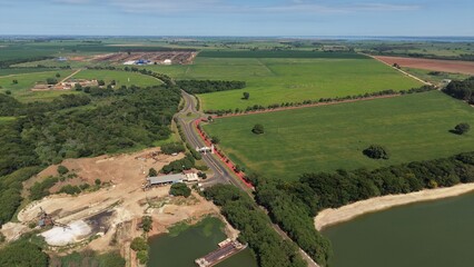 Naklejka premium An aerial view of a rural landscape with a road and construction site