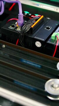 Electronic device with conveyor belt and screen changing colors. Media