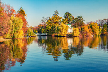 Fototapeta premium Stunning view to Upper Pond and Pink Pavilion on Island of Anti-Circe in Sofiyivka park, Uman, Ukraine at sunny autumn day