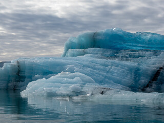 Blue iceberg with crystal structure floating in Iceland's Jokulsarlon Glacier Lagoon