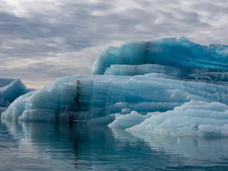 Blue iceberg with crystal structure floating in Iceland's Jokulsarlon Glacier Lagoon