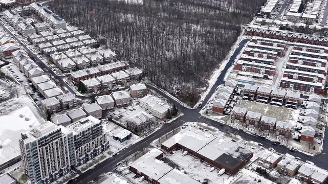 Aerial winter view of Montreal suburbs, snowy angrignon park and river near Lachine and Verdun under cloudy sky. g.