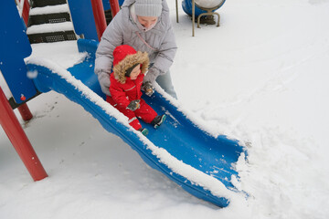 Winter Fun on Snowy Playground Slide