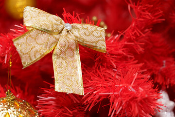 Bright bow on a festive red decoration amidst ornaments during a holiday celebration
