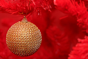 Christmas ornament hanging on red tree decoration during holiday season