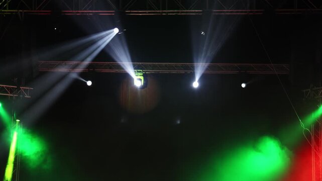 Dynamic stage lighting effects illuminate a performance area with vibrant colors and beams of light creating an engaging atmosphere for an upcoming event