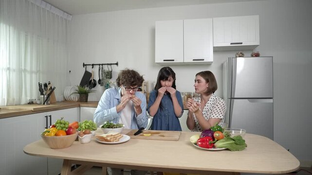 Happy caucasian father and mother sitting and eating fruit at modern kitchen. Energetic family spend time together by enjoy eating fruit or healthy fruit with kitchenware and fruit on table. Pedagogy.