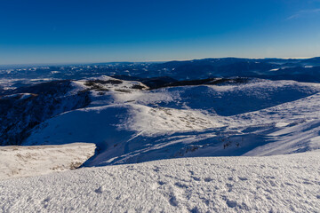 Schneeberg mountain in winter with snow covered slopes and alpine terrain in the Austrian Alps near Vienna. High altitude landscape showing cold climate conditions, rocky ridges, winter season environ