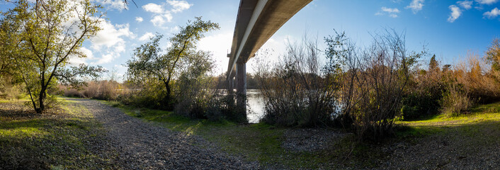 panoramic under the bike trail bridge over American River at River Bend Park