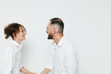 A professional man and colleague share a warm moment against an isolated colored background, communicating confidence, teamwork, and positive emotion in a business setting, while presenting a calm,