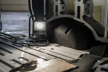 Industrial vehicle manufacturing workshop with metal bus frames and body structures under assembly....