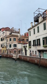 Venice canals with historical buildings and boats, winter day in Italian city