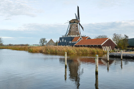 View of the De Rat sawmill in autumn. De Rat is an octagonal smock mill in IJlst Friesland The Netherlands and was built in 1828. De Rat is one of three sawmills in Friesland. Image with copy space.	