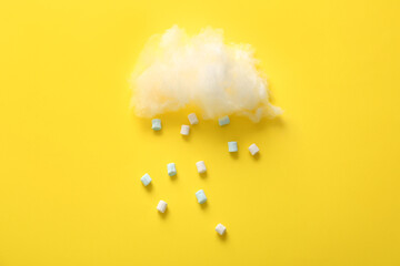 Composition with cotton candy cloud and marshmallows on yellow background