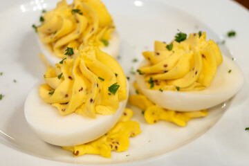 Traditional french boiled eggs mimosa stuffed with yolk, mayonnaise and herbe, served in bouillon bistro restaurant in Paris