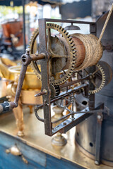 Traditional vintage French equipment for roasting and grilling fresh chestnuts over open fire, delicious street food, eating nuts on streets of Paris in autumn