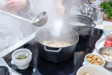 High cuisine cooking experince with chef in cook studio in Paris, preparation of different fine dishes with vegetables, truffle mushrooms, red bits, black salsify, nuts